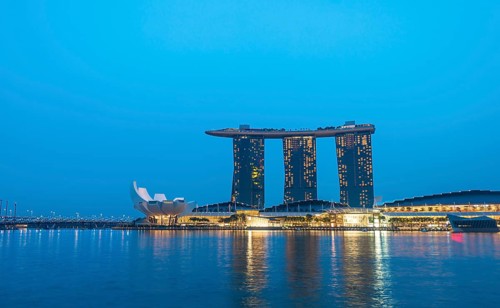 Marina Bay Sands Hotel by the Singapore River at dusk