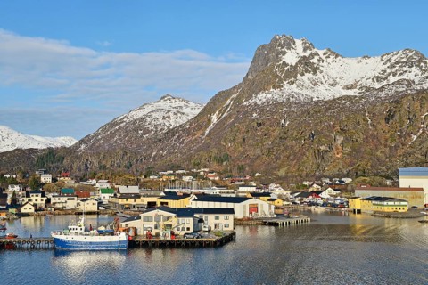 Harbor area with a boat in front of mountain scenery