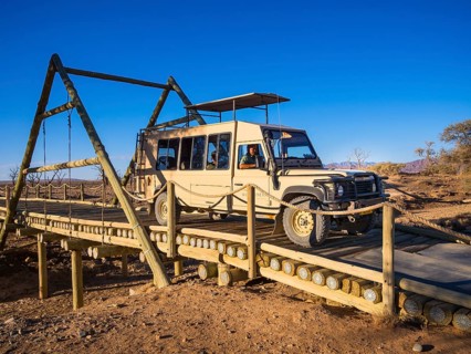 Land Rover crossing a wooden bridge in the Kulala Wilderness Reserve on the edge of the Namib Desert