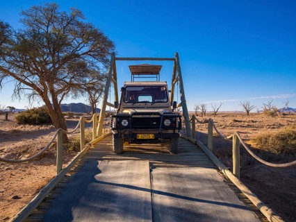 Land Rover crossing a wooden bridge in the Kulala Wilderness Reserve on the edge of the Namib Desert