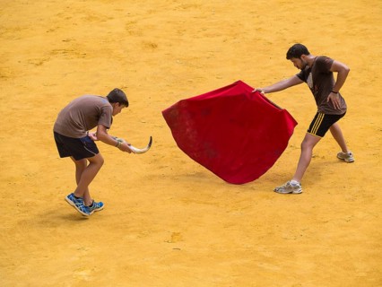 Toreros practicing bullfighting in bullring