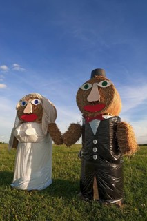 Wedding couple built of straw bales in a meadow