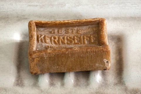Piece of curd soap on an old sink in a former factory