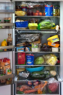 Crammed refrigerator with various foods
