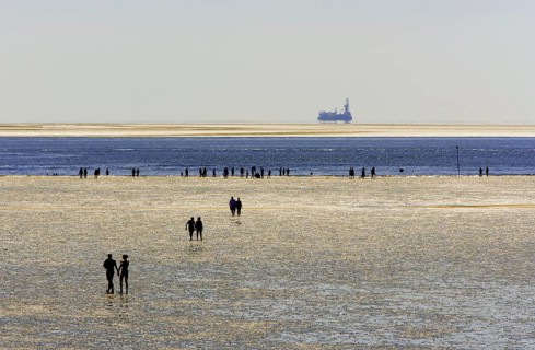 Strollers walking at low tide on the foreshore