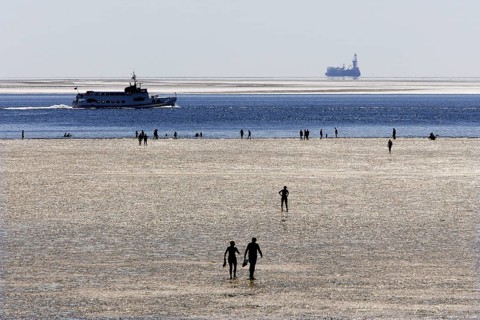 Strollers walking at low tide on the foreshore