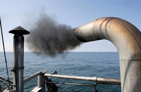 Trawler on a fishing trip with a dark marine diesel smoke cloud