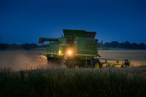 Combine harvester harvesting at night