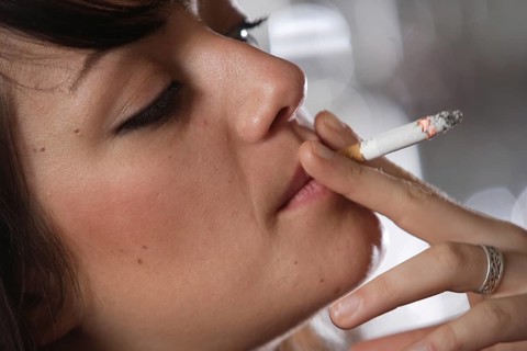 Young woman smoking in a bar or bistro
