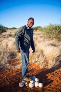 Local man standing on ostrich eggs