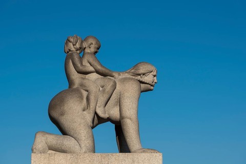 Children riding on woman's back