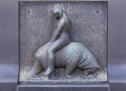 Young woman sitting on bear