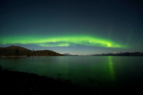 Aurora borealis and moonlight over Prince William Sound
