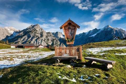 Way-side cross in front of Walder Alm and Karwendel Mountains