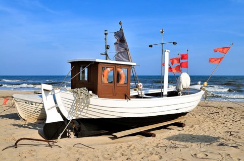 Fishing boat with red marker flags