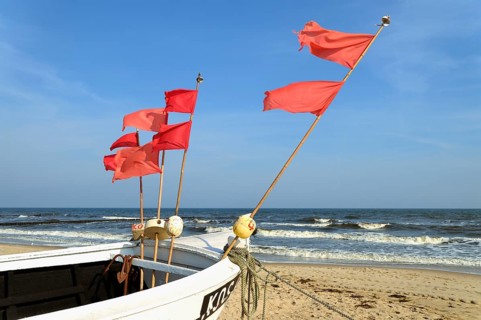 Fishing boat with red marker flags