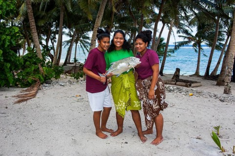 Samoan girls holding their fresh catch