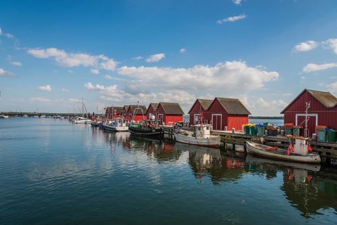 Red cottage with fishing boats