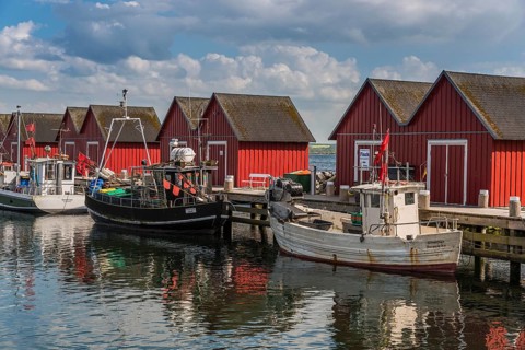 Red cottage with fishing boats