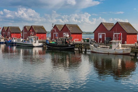 Red cottage with fishing boats