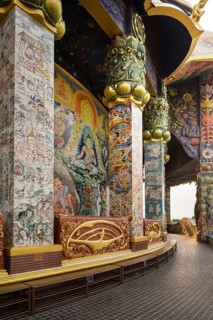 Columns with ceramic images in the gallery of the Elephant Temple Thep Wittayakhom Vihara