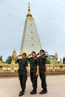 Female soldiers of the Thai Army in front of stupa in Wat Phra That Nong Bua