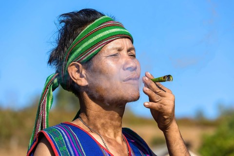 Man in traditional costume smoking cigar