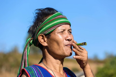 Man in traditional costume smoking cigar