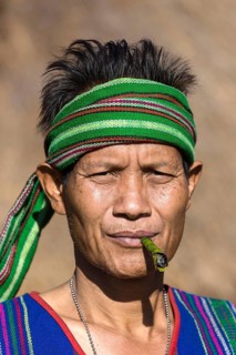 Man in traditional costume smoking cigar
