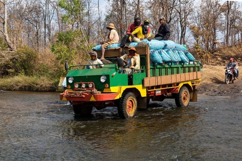 Truck crossing the river at the Bousra waterfall
