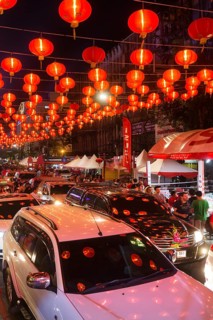 Red chinese lanterns reflecting on cars
