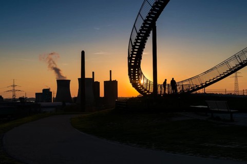 Power plant with part of the Tiger and Turtle sculpture at sunset