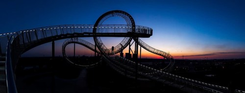 Power plant with part of the Tiger and Turtle sculpture at sunset