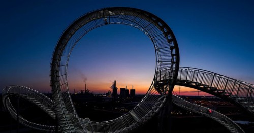 Power plant with part of the Tiger and Turtle sculpture at sunset