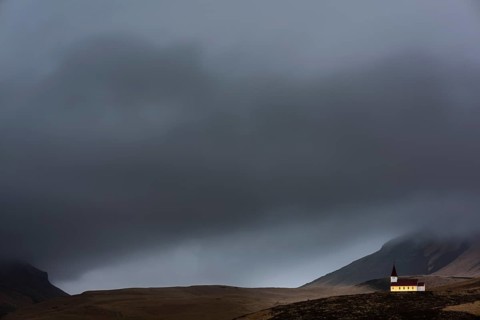 Vik i Myrdal church with mountains and fog