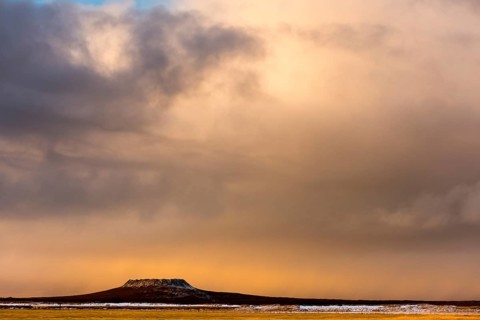 Volcanic cone with cloudy sky