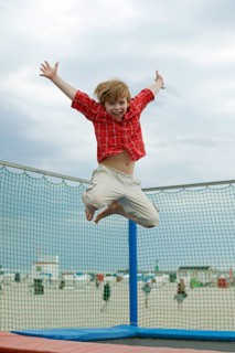 Boy jumping on trampoline