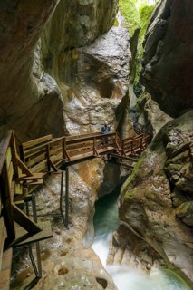 Wooden boardwalk in gorge with stream