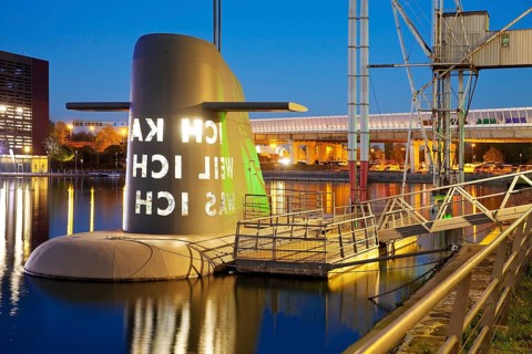 Work of art submarine island at the Kuppersmuhle Museum at dusk