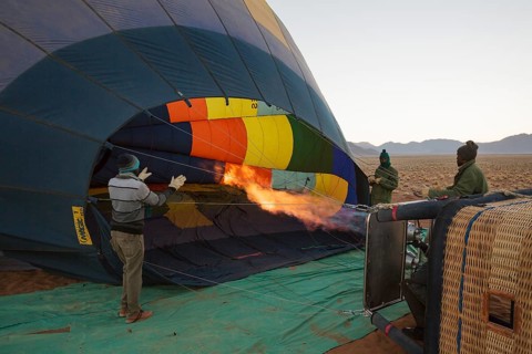 Pilot inflating hot air balloon with two burners