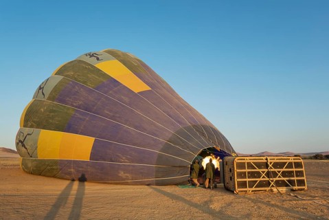 Pilot inflating hot air balloon with two burners