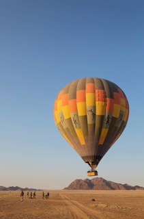Hot-air balloon just taken-off in the early morning