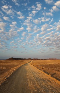 Gravel road on arid plain