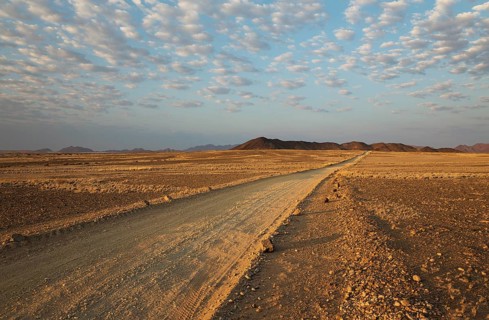 Gravel road on arid plain