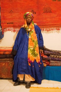 Colourful outfit of an employee in a carpet shop in Tafraoute