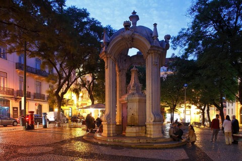 Largo do Carmo square with drinking fountain Chafariz do Carmo at dusk