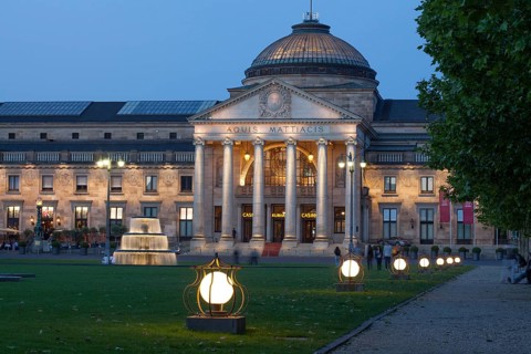 Spa hotel with fountain and park Bowling Green at dusk