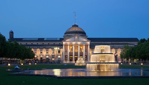 Spa hotel with fountain and park Bowling Green at dusk