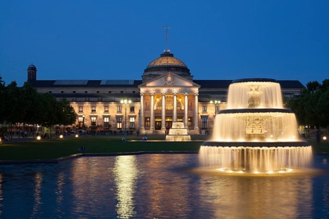Spa hotel with fountain and park Bowling Green at dusk