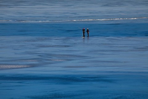 Elderly couple ice skating on frozen Glafsfjorden